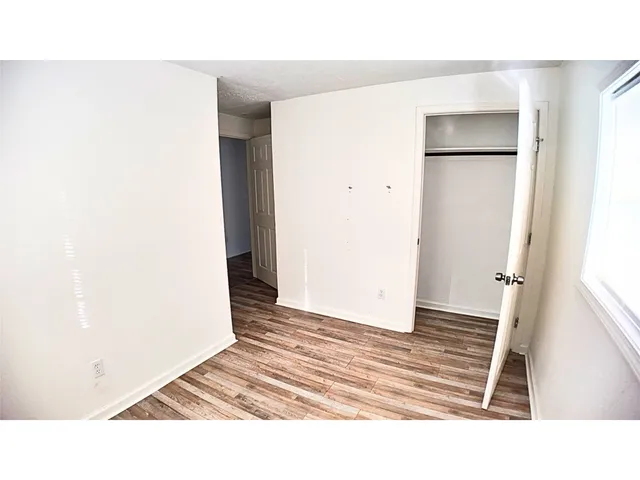 a view of a room with wooden floor