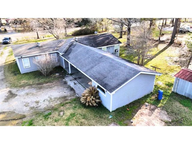 a aerial view of a house with pool and a yard