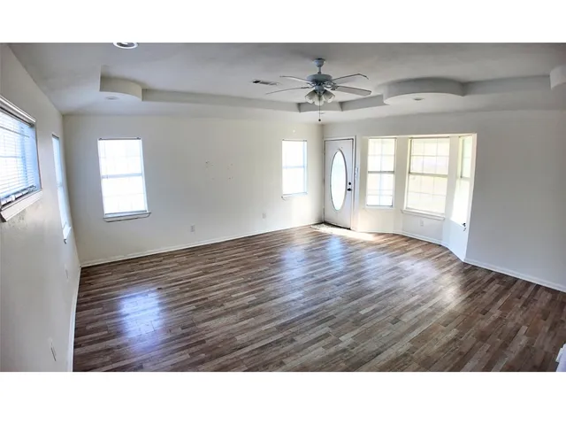 a room with wooden floor and window