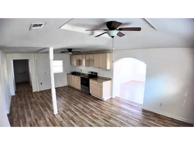 a living room with stainless steel appliances kitchen island furniture and a kitchen view