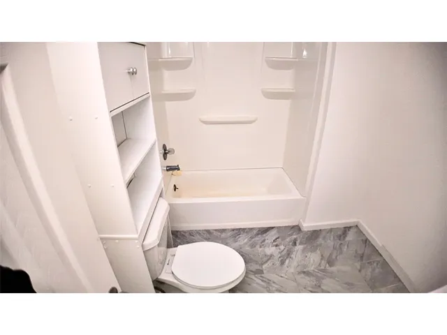 a bathroom with a sink a toilet and a shower