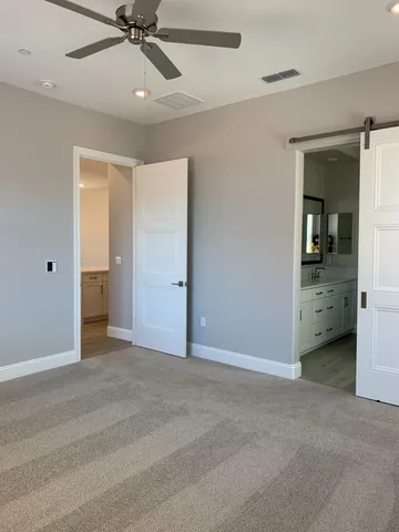 a view of an empty room and a bathroom