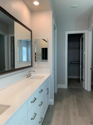a bathroom with a double vanity sink and a mirror