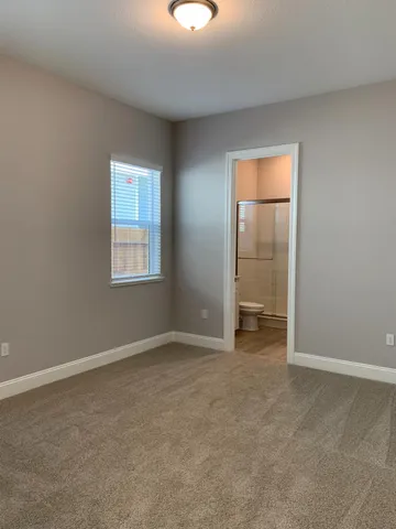 an empty room with closet and mirror
