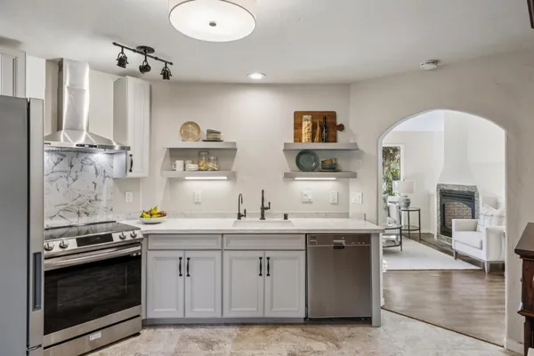 a kitchen with stainless steel appliances a stove sink and cabinets