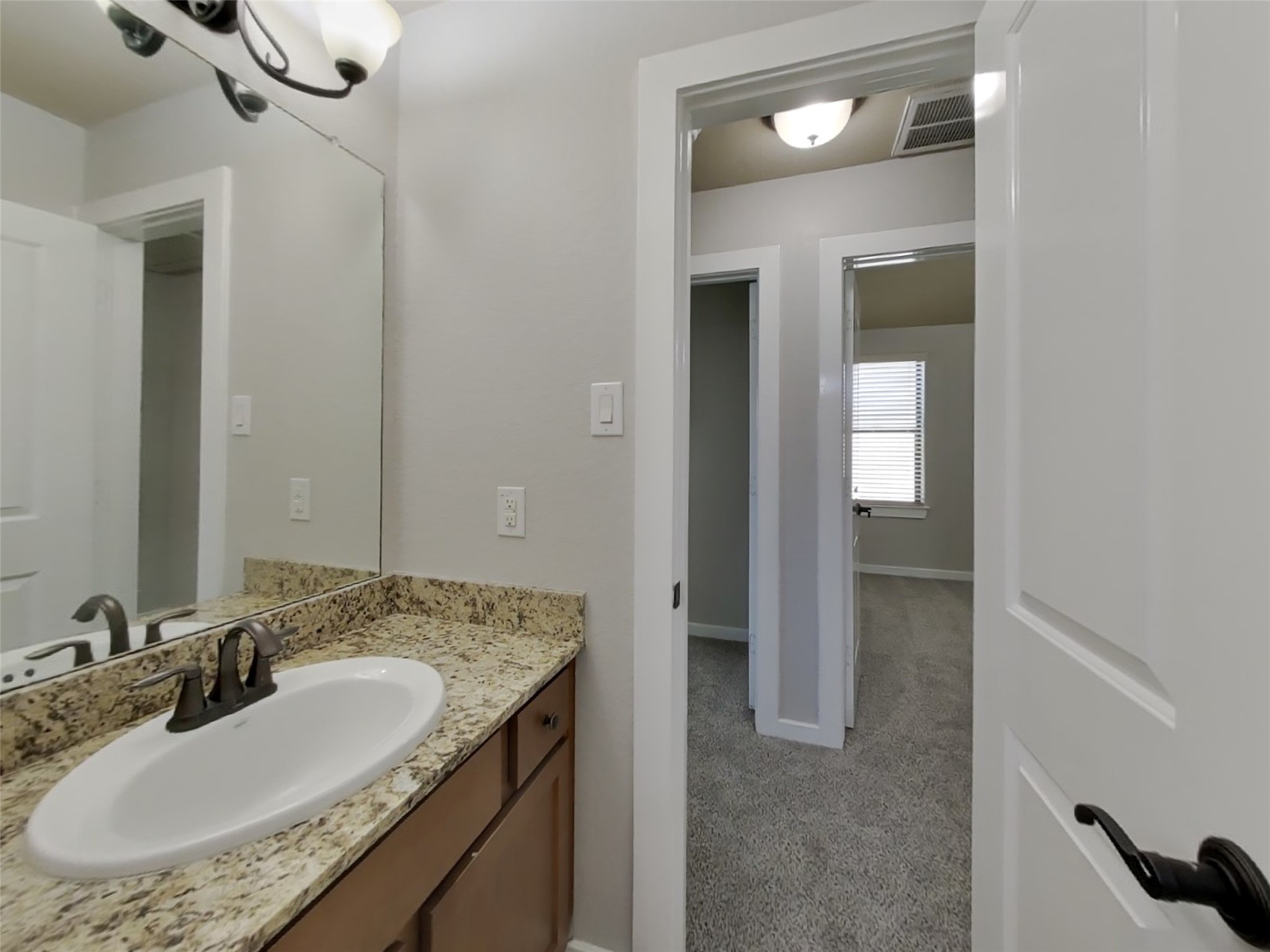 1819 Jara Court Spring, TX 77388 - Photo 18 of 19 a bathroom with a granite countertop sink a mirror and shower