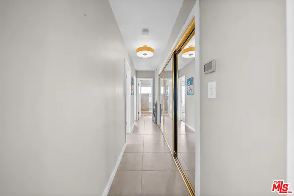 a view of a hallway with wooden floor and windows