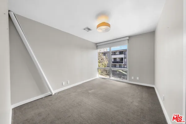 a view of an empty room with a window