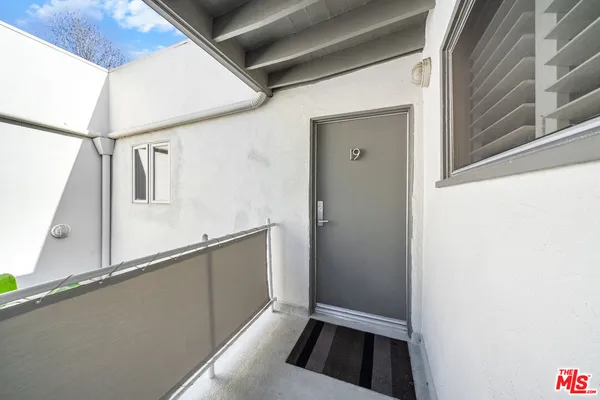 a view of walk in closet with wooden floor