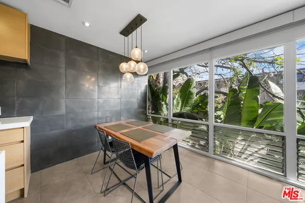 a view of a dining room with furniture window and outside view
