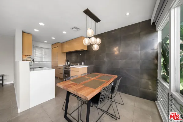 a kitchen with a table and chairs in it