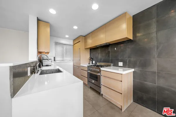 a kitchen with a sink appliances and cabinets