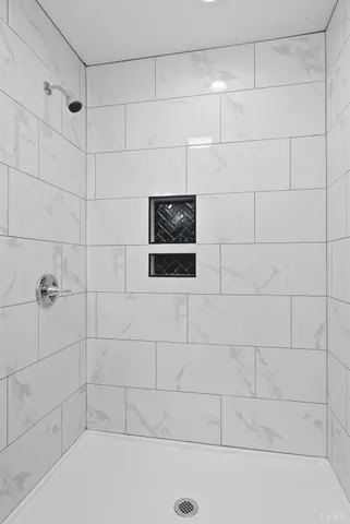 a bathroom with a granite countertop tub sink and mirror