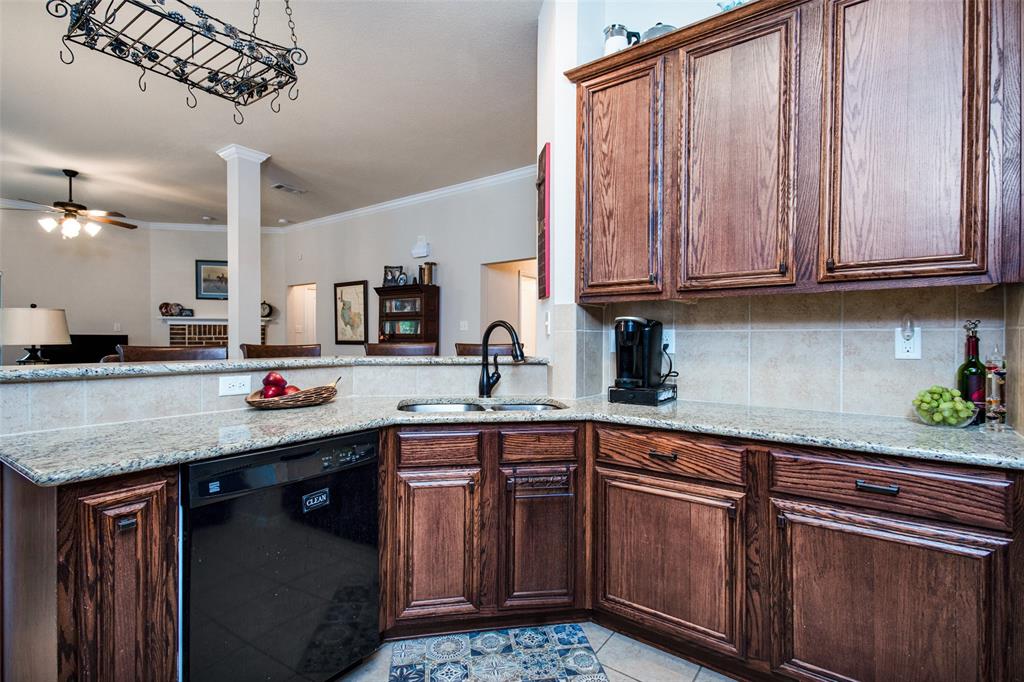 a kitchen with stainless steel appliances granite countertop a sink a stove cabinets and wooden floor