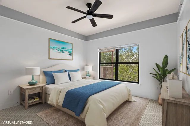 a bedroom with a large bed and a window