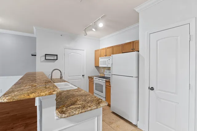 a kitchen with a stove and a refrigerator