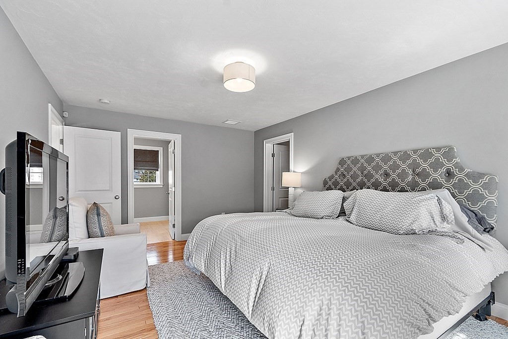 78 Hutchinson Road Sutton, MA 01590 - Photo 21 of 36 a bedroom with a bed and a flat tv screen on dresser