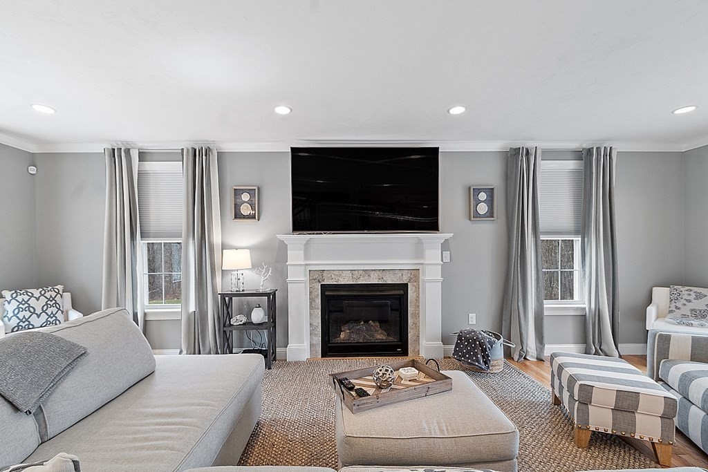 78 Hutchinson Road Sutton, MA 01590 - Photo 5 of 36 a living room with furniture a fireplace and a flat screen tv