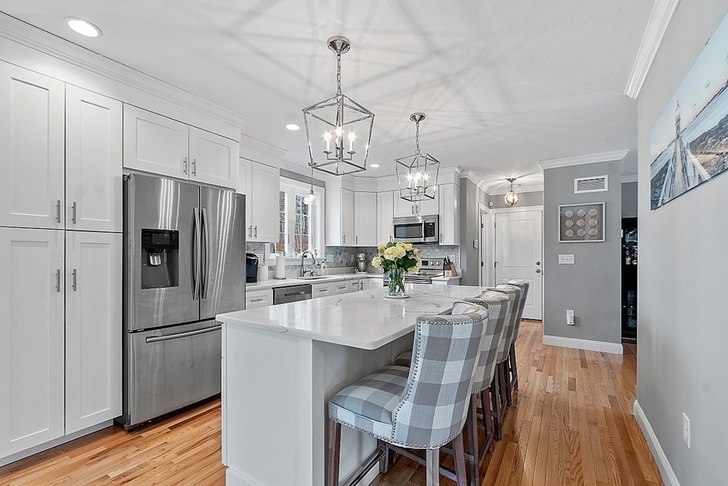 78 Hutchinson Road Sutton, MA 01590 - Photo 8 of 36 a kitchen with refrigerator a sink and chairs