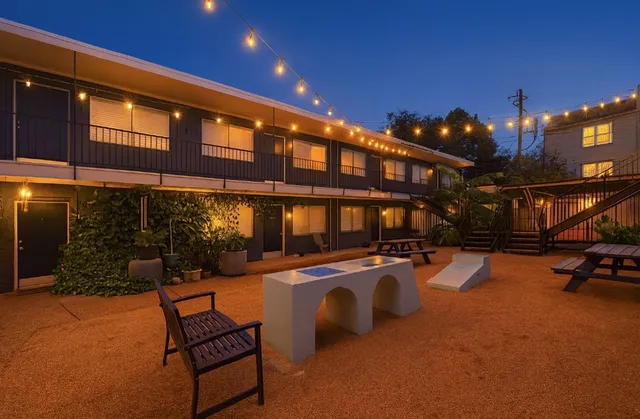 a outdoor patio with swimming pool and furniture