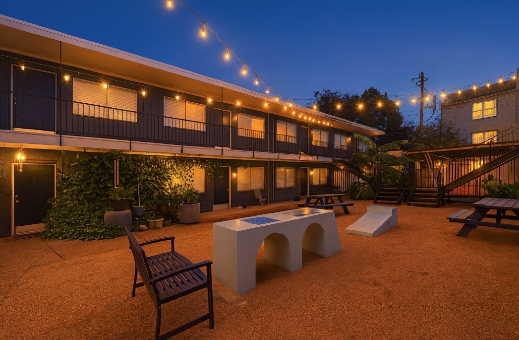 a outdoor patio with swimming pool and furniture