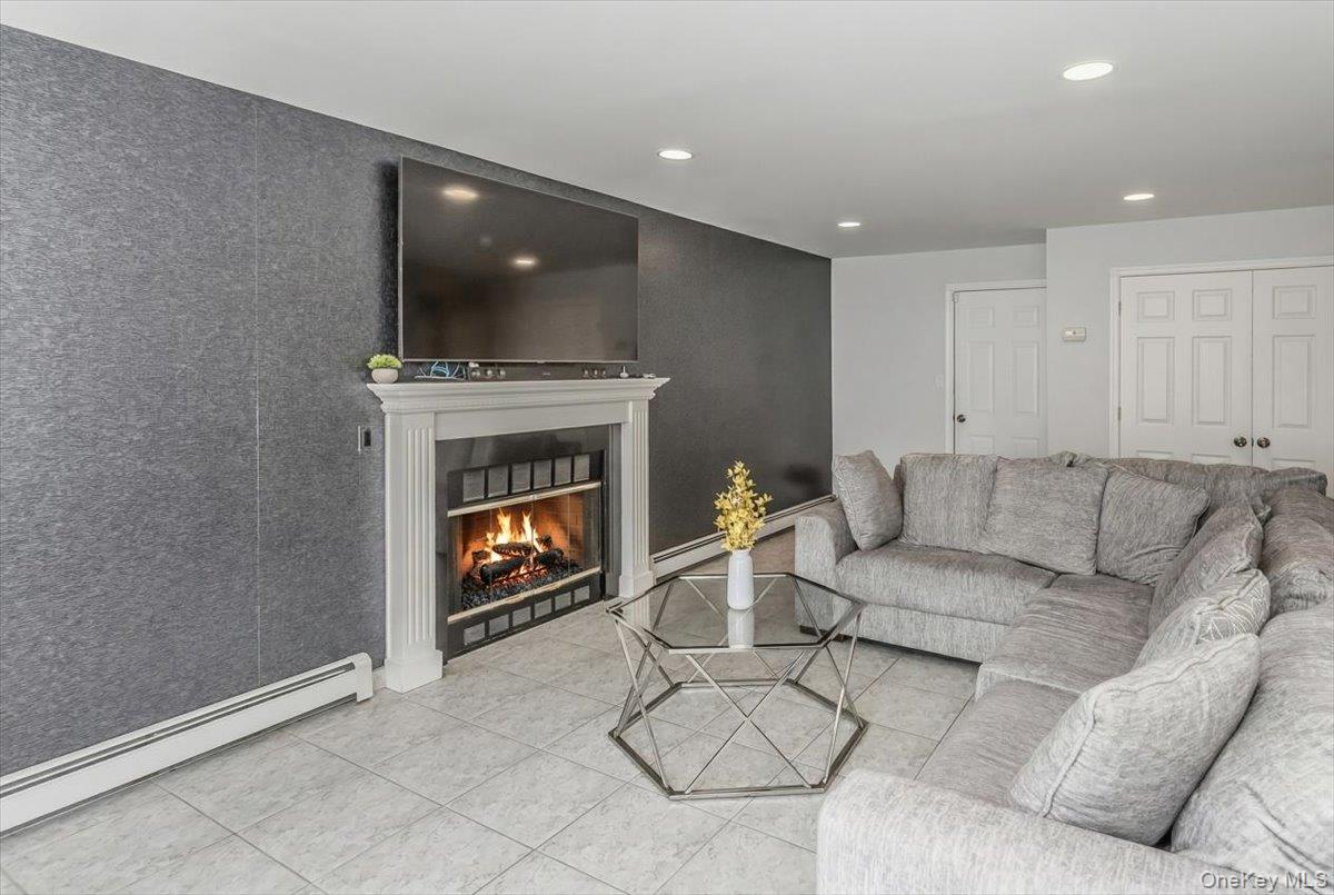 263 James Street Franklin Square, NY 11010 - Photo 11 of 23 a living room with furniture and a fireplace