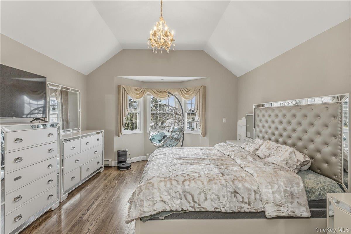 263 James Street Franklin Square, NY 11010 - Photo 14 of 23 a spacious bedroom with a large bed and a dresser