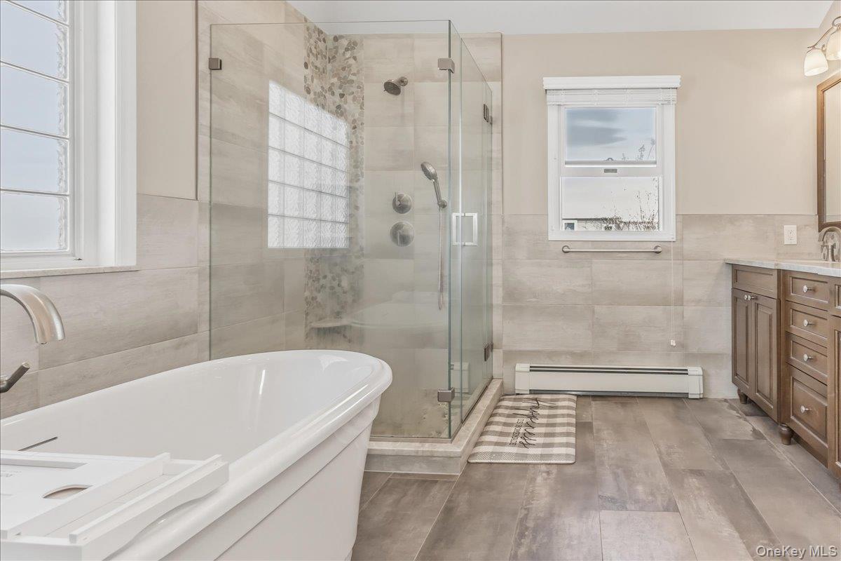 263 James Street Franklin Square, NY 11010 - Photo 15 of 23 a bathroom with a bathtub and a shower