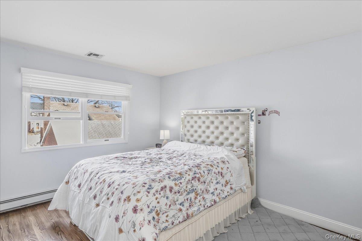 263 James Street Franklin Square, NY 11010 - Photo 16 of 23 a bedroom with a bed and wooden floor