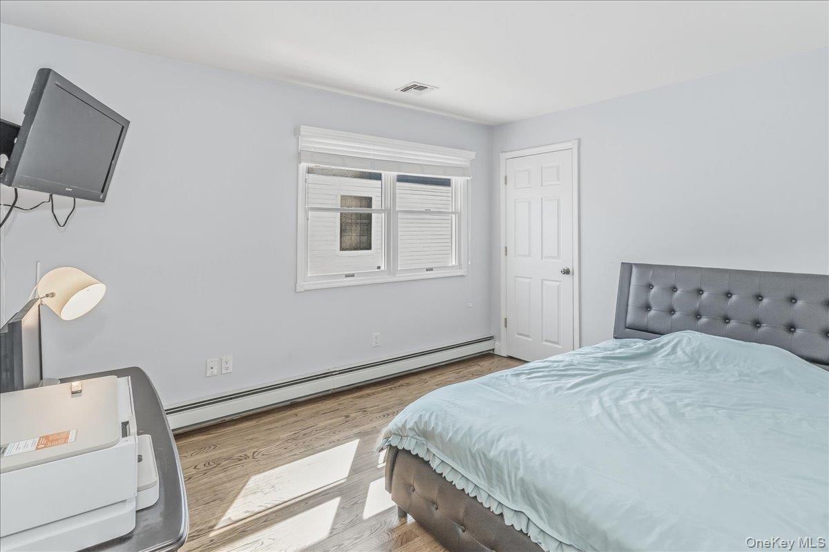 263 James Street Franklin Square, NY 11010 - Photo 17 of 23 a bedroom with a bed and a flat screen tv