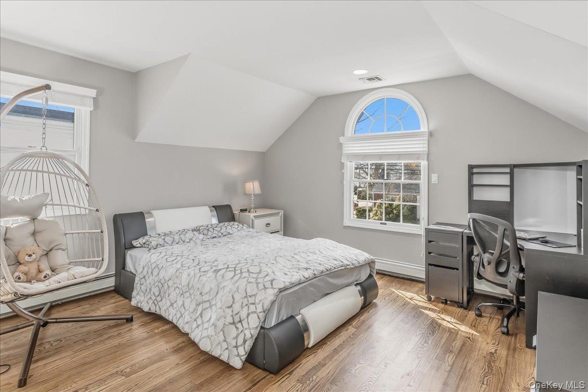 263 James Street Franklin Square, NY 11010 - Photo 18 of 23 a bedroom with a bed and a table in it