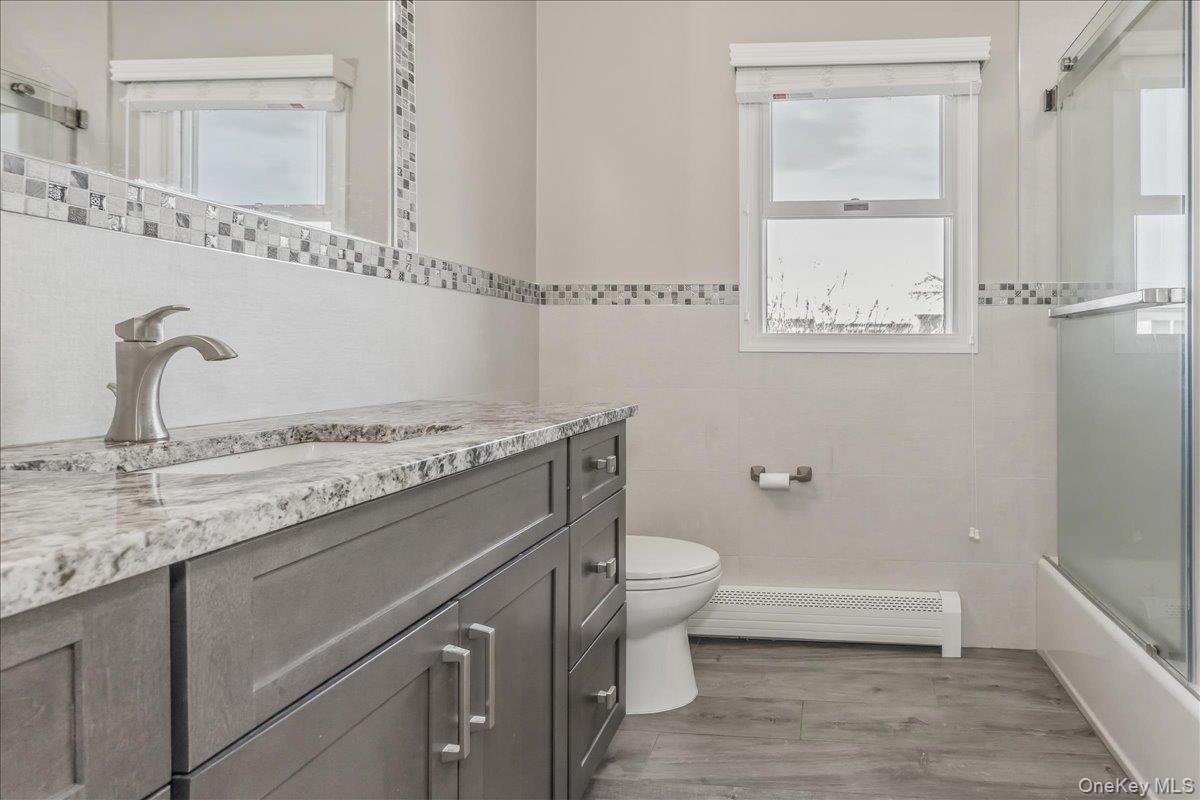 263 James Street Franklin Square, NY 11010 - Photo 19 of 23 a bathroom with a granite countertop sink toilet and shower