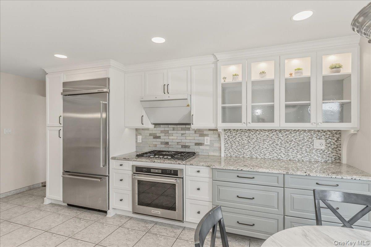 263 James Street Franklin Square, NY 11010 - Photo 6 of 23 a kitchen with white cabinets and appliances