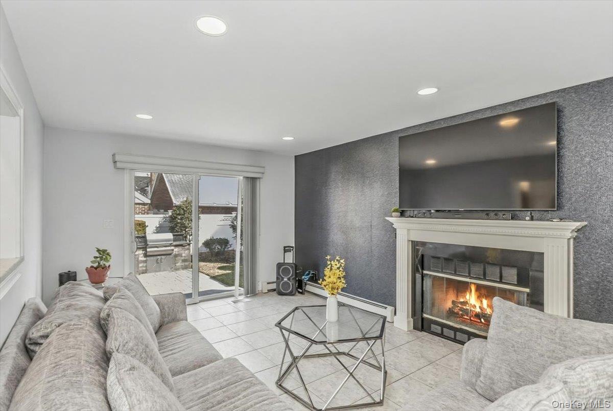 263 James Street Franklin Square, NY 11010 - Photo 9 of 23 a living room with furniture and a fireplace