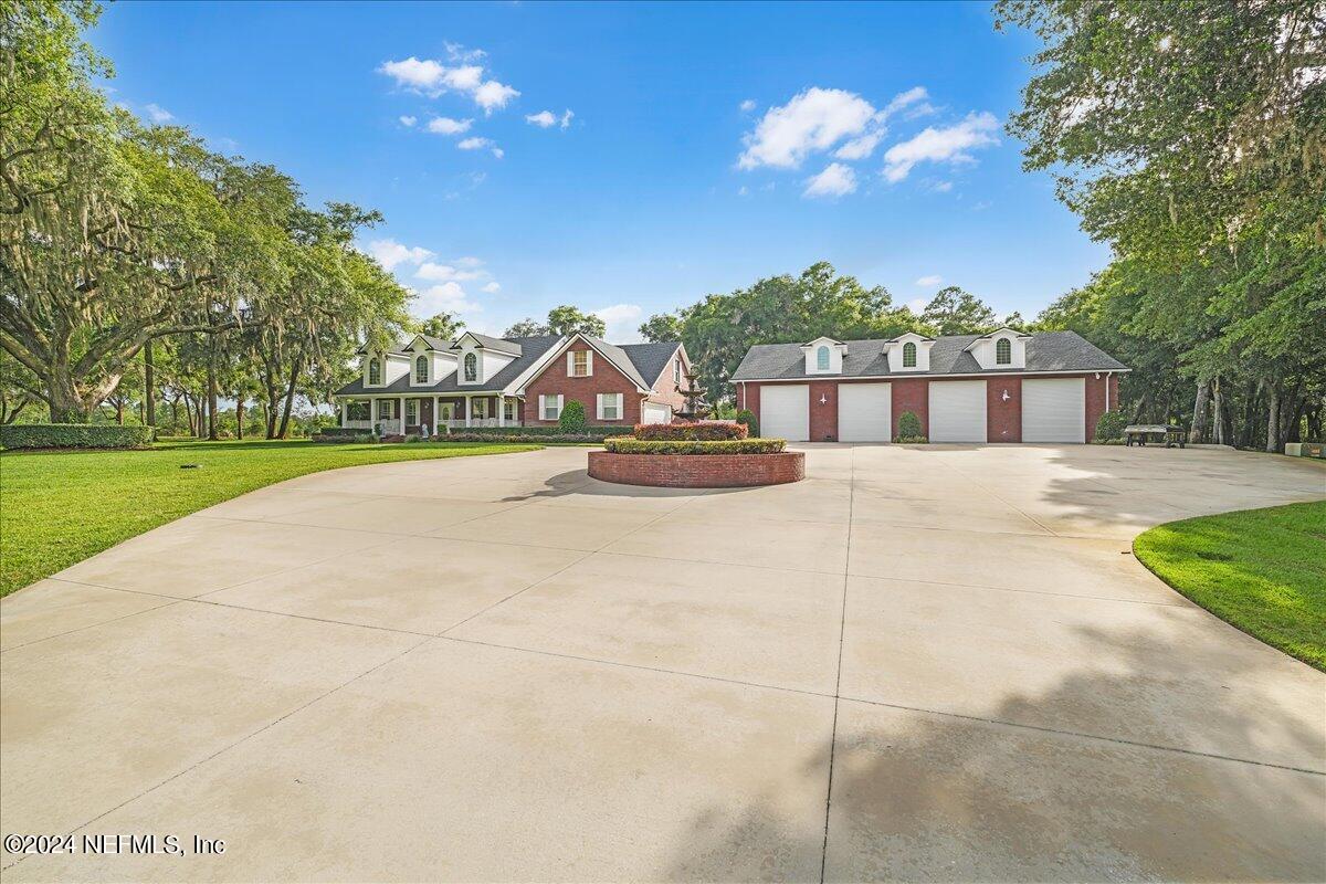 87359 Raddin Road Yulee, FL 32097 - Photo 4 of 80 a view of a house with a yard and potted plants
