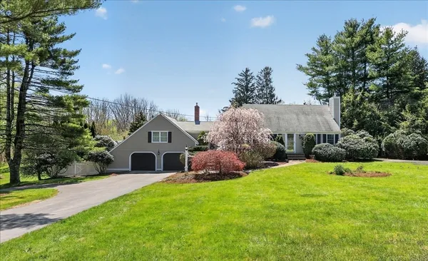 a house with green field in front of it
