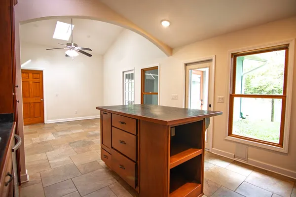 a kitchen with stainless steel appliances granite countertop a stove a sink and a refrigerator