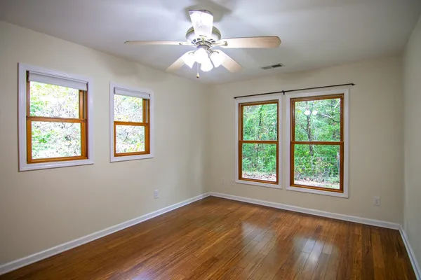 a bathroom with a toilet a sink and a window