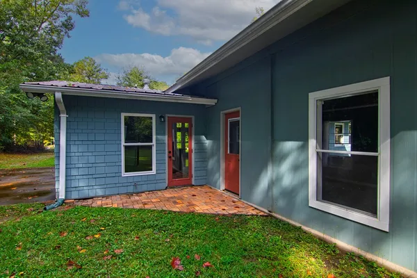 a view of a house with a yard and a garden