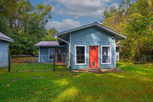 an aerial view of residential houses with outdoor space and trees