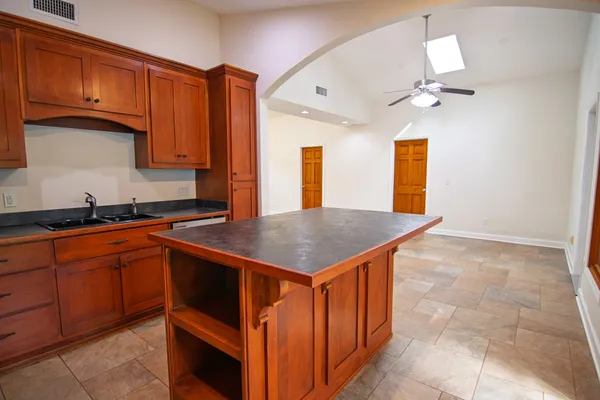 a kitchen with stainless steel appliances granite countertop a sink stove and microwave