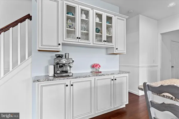 a kitchen with cabinets and wooden floor