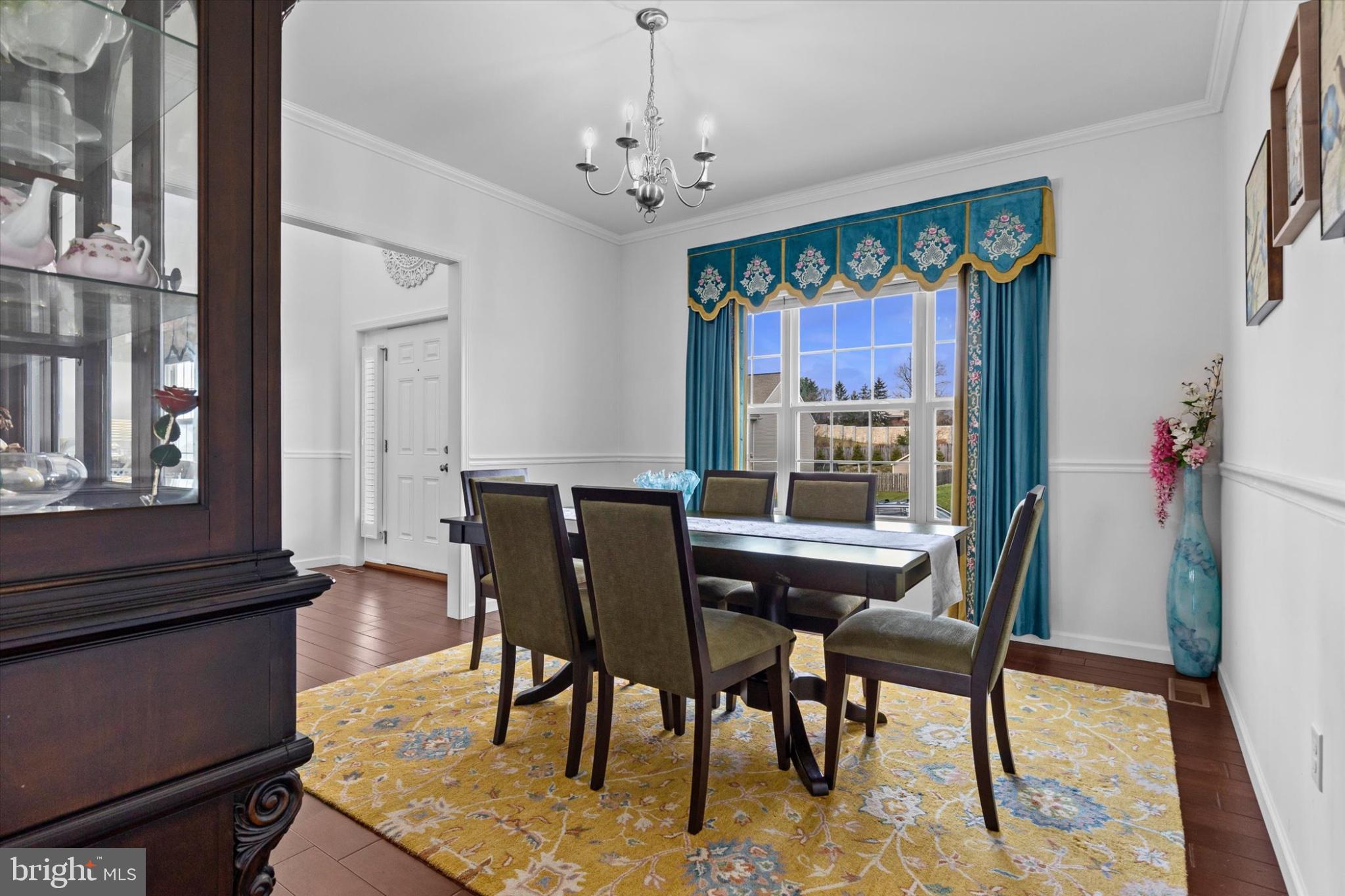 3 Rycroft Road Mechanicsburg, PA 17050 - Photo 17 of 55 a dining room with furniture a rug a potted plant and a chandelier