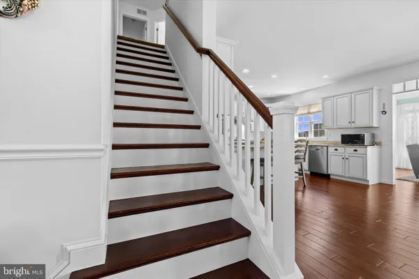 a view of entryway and hall with wooden floor