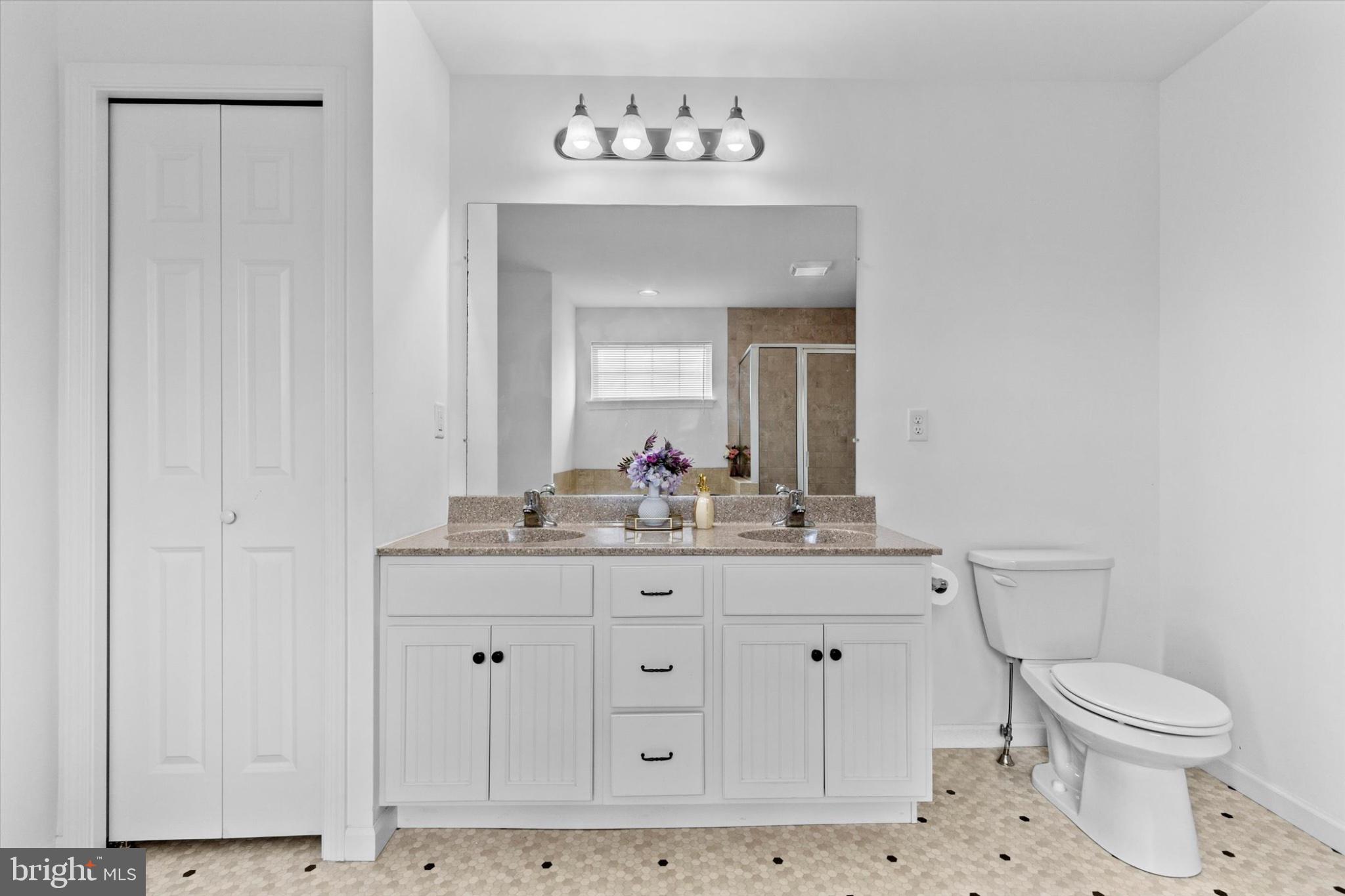3 Rycroft Road Mechanicsburg, PA 17050 - Photo 24 of 55 a bathroom with a granite countertop toilet a sink and a mirror
