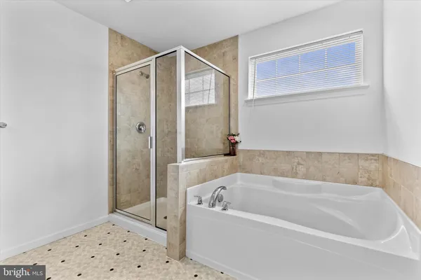 a bathroom with a bathtub and a shower