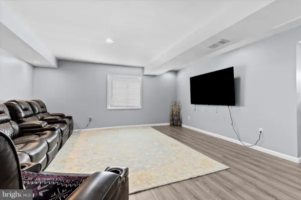 a view of a workspace with furniture and wooden floor