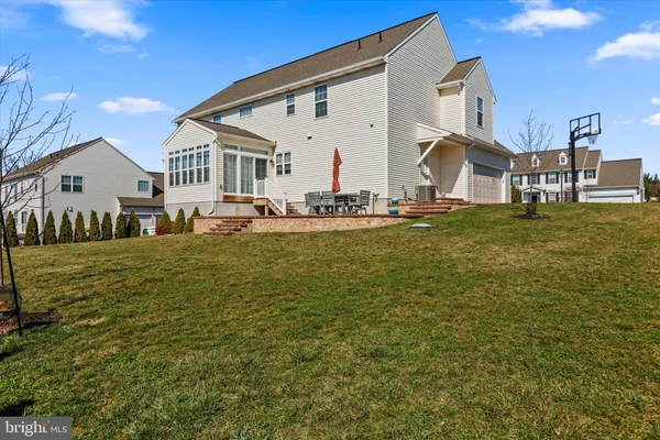 a view of a house with backyard porch and sitting area