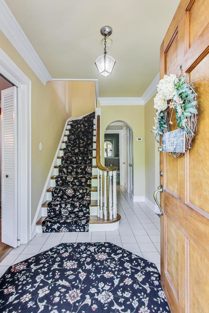 315 Elmore Street Park Ridge, IL 60068 - Photo 4 of 39 a view of a hallway with wooden floor and staircase