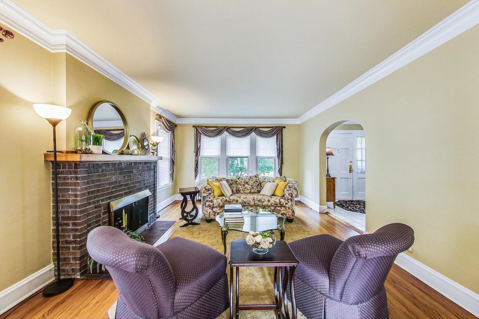 315 Elmore Street Park Ridge, IL 60068 - Photo 8 of 39 a living room with furniture a fireplace and a large window
